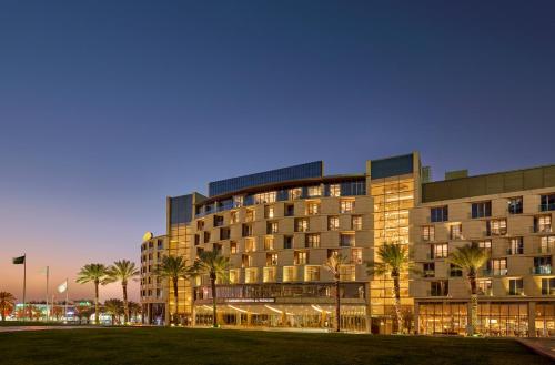 a large building with palm trees in front of it at Mandarin Oriental Al Faisaliah, Riyadh in Riyadh