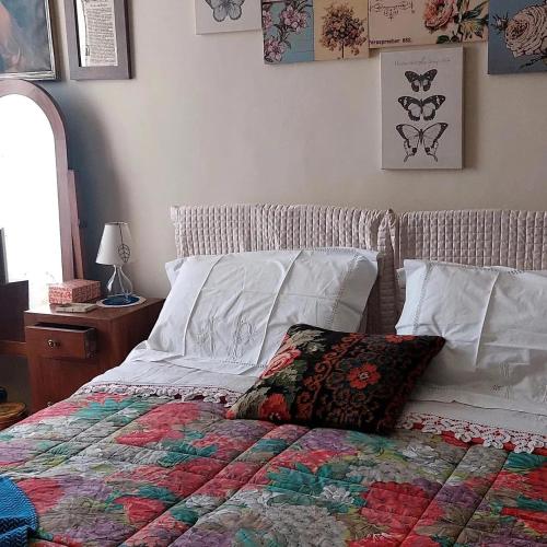 a bed with a quilt and a pillow on it at La casa di Zia Mimina in Civitella Casanova