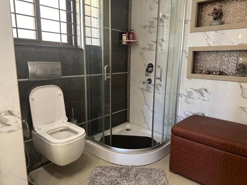 a bathroom with a shower with a toilet and a sink at super nova 1 in Lahore