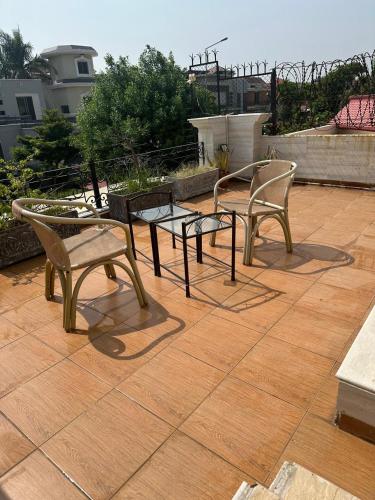two chairs and a table on a patio at super nova 1 in Lahore
