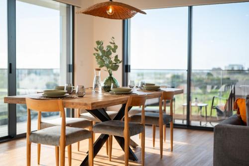 a dining room with a wooden table and chairs at Priolo in Ponta Delgada - 5th floor Apartment in Ponta Delgada