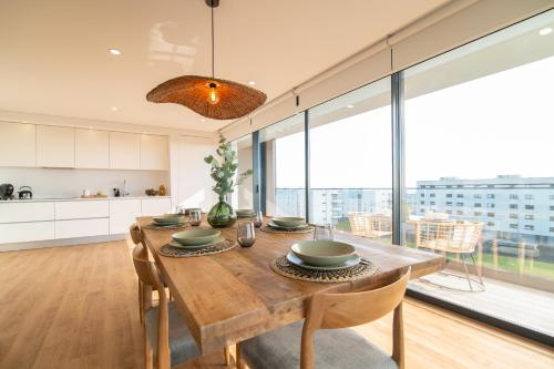 a kitchen and dining room with a wooden table at Priolo in Ponta Delgada - 5th floor Apartment in Ponta Delgada