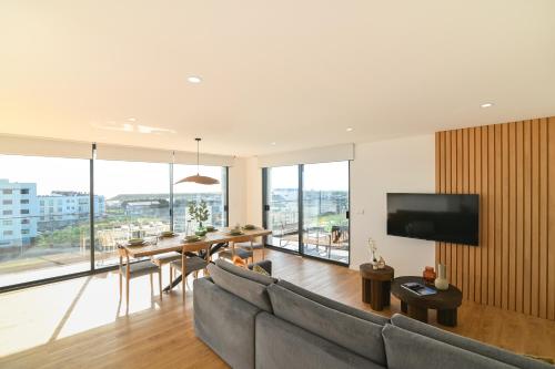 a living room with a couch and a table at Priolo in Ponta Delgada - 5th floor Apartment in Ponta Delgada