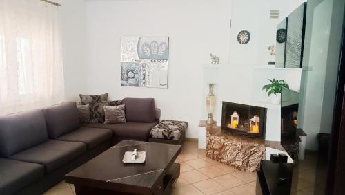 a living room with a couch and a coffee table at Lyra's house in Skiathos Town