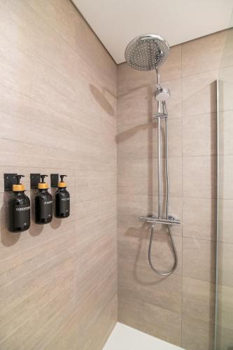 a shower with a shower head in a bathroom at Priolo in Ponta Delgada - 5th floor Apartment in Ponta Delgada