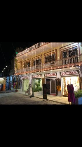a large building with a store front with lights at Gautama Hotel in Khajurāho