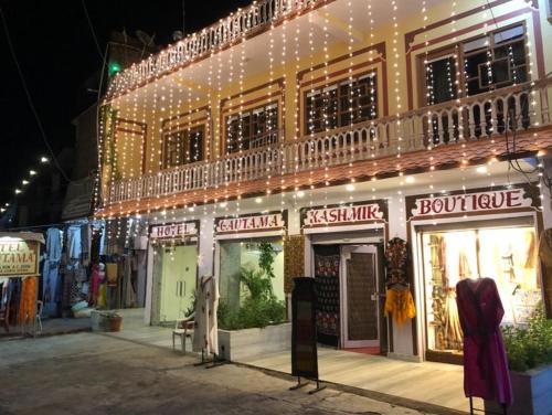 a building with christmas lights on the side of it at Gautama Hotel in Khajurāho
