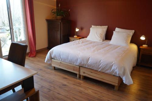 a bedroom with a large bed with white sheets and pillows at Gite MontBlanc in Verrens-Arvey