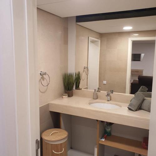a bathroom with a sink and a mirror at Center Marina View Brown Studio in Funchal