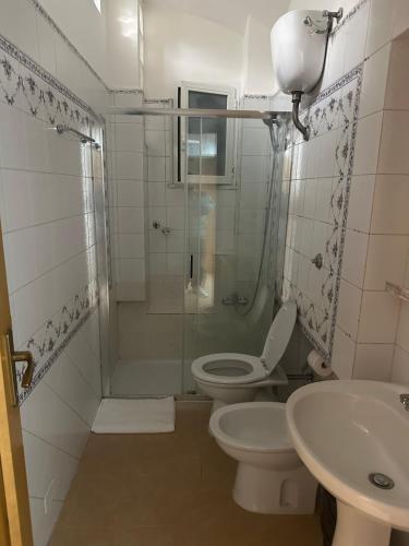 a bathroom with a shower and a toilet and a sink at Western Termini Guest House in Rome