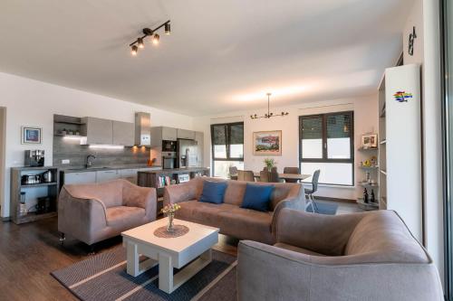 a living room with two couches and a table at Korcula Luxury Apartments in Korčula