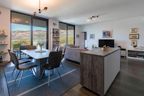 a living room with a table and chairs and a couch at Korcula Luxury Apartments in Korčula