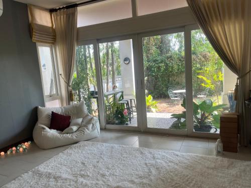 a bedroom with a large bed and a large sliding glass door at Garden and Yoga Stay in Ban Wat Sadet (1)