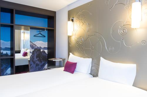 a hotel room with a bed and a window at VISIONAPARTMENTS Place de Cornavin - contactless check-in in Geneva