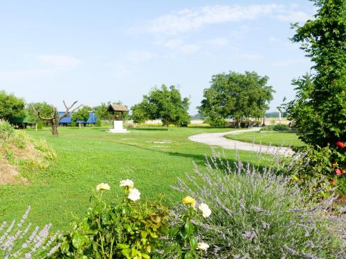a park with flowers and a pathway at Tisza White House in Tiszaszőlős