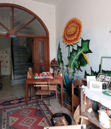 a room with a table with a sunflower on the wall at La casa di Zia Mimina in Civitella Casanova