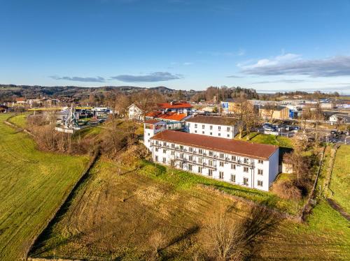an aerial view of a town with a white building at Hotel Irschenberg Süd in Irschenberg