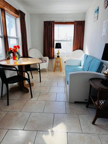 a living room with a blue couch and a table at Buccaneer Quarters and Suites in Marathon