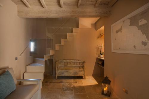 a hallway with a staircase with a wooden stair case at Camere di Via Montebello in Castagneto Carducci