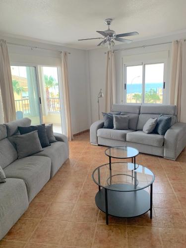 a living room with a couch and a table at Penthouse & Jacuzzi With Sea Views In Costa Blanca in Orihuela Costa