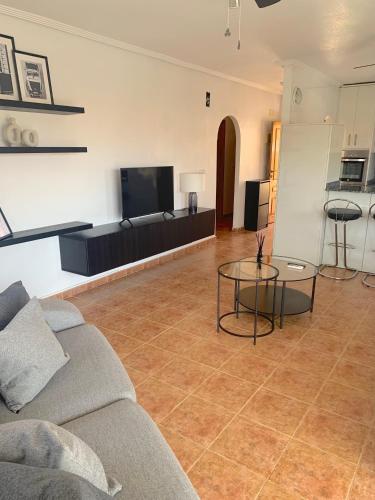 a living room with a couch and a table at Penthouse & Jacuzzi With Sea Views In Costa Blanca in Orihuela Costa
