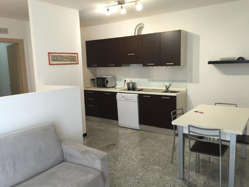 a kitchen with a couch and a table in a room at Casa Lampone in Trento