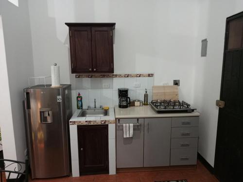 a small kitchen with a refrigerator and a sink at Apartment T46 in Antigua Guatemala