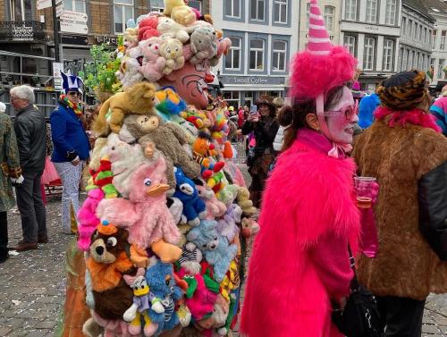 a woman in a pink costume standing next to a pile of stuffed animals at BelleVie Apartment, Eijsden-Maastricht in Eijsden