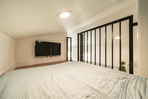 a bedroom with a large bed and a flat screen tv at Zion Oasis Rentals in Hurricane