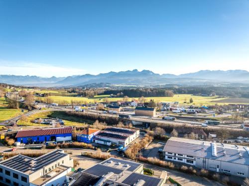 an aerial view of a city with mountains in the background at Hotel Irschenberg Süd in Irschenberg