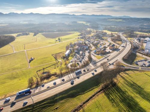 an aerial view of a city with a highway at Hotel Irschenberg Süd in Irschenberg