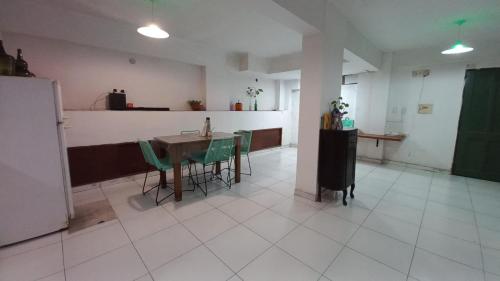 cocina con mesa y sillas verdes en una habitación en LOFT en Barrio Sur, en San Miguel de Tucumán