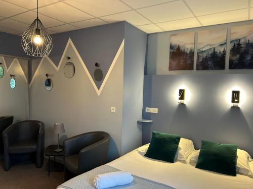 a hospital room with a bed and two chairs at Logis Hôtel de Paris in Murol