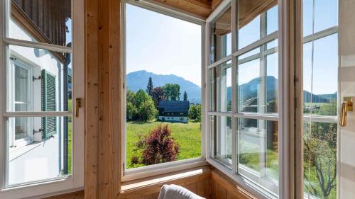 a room with windows with a view of a field at Villa Bellevue Altaussee in Altaussee