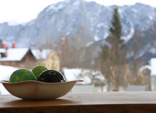 a bowl of easter eggs on a table with a mountain at Villa Bellevue Altaussee in Altaussee