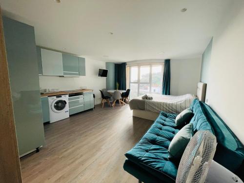 a living room with a couch and a kitchen at Center Marina view Green Studio in Funchal