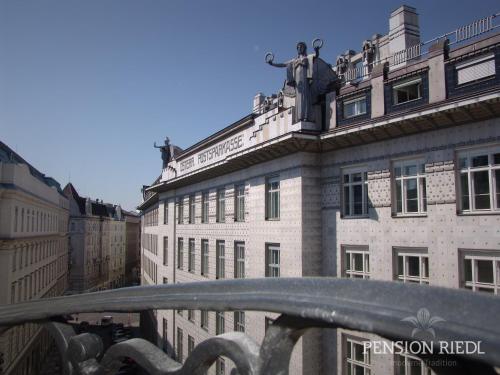 a large brick building with a statue on top of it at Pension Riedl in Vienna