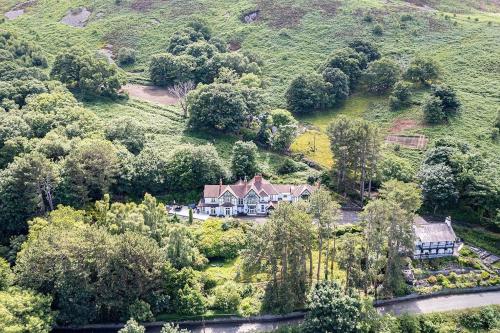 an aerial view of a house in the trees at Delightful holiday home with sea views and Hot Tub in Penmaen-mawr