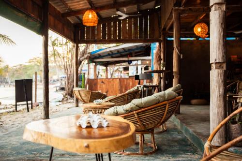 a table and chairs in a room with a table at Koalama Cambodia in Koh Rong Sanloem