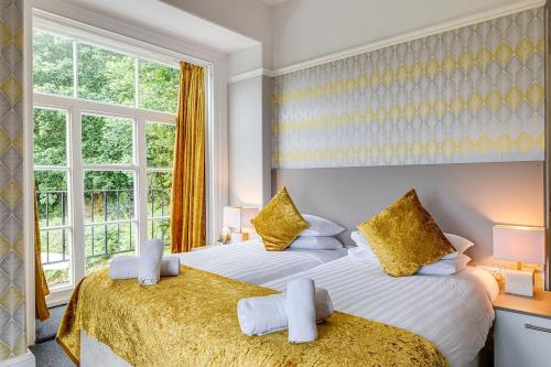 a bedroom with two beds and a window at Delightful holiday home with sea views and Hot Tub in Penmaen-mawr