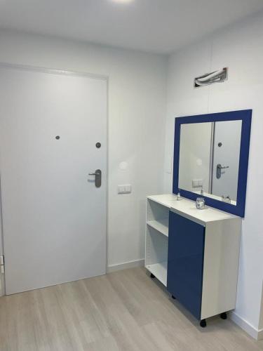a white room with a mirror and a desk with a sink at Center Marina view Blue Studio in Funchal