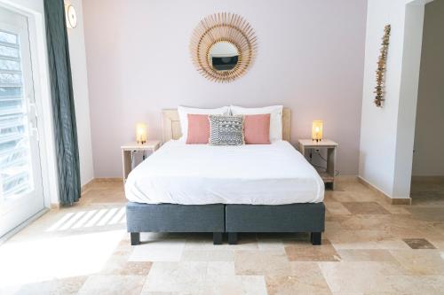 ein Schlafzimmer mit einem Bett und zwei Tischen mit Kerzen in der Unterkunft Bliss Bonaire by Boutique Bonaire Unique Resorts in Kralendijk