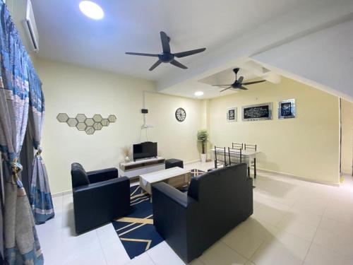 a living room with couches and a ceiling fan at Arissa Homestay dTangkak in Tangkak