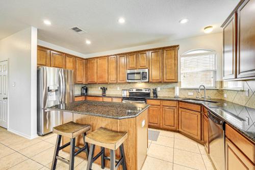 a kitchen with wooden cabinets and stainless steel appliances at 5 Mi to Randolph AFB Spacious Cibolo Haven! in Cibolo