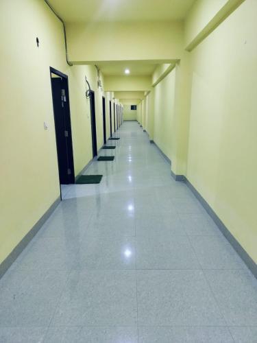 an empty hallway of a building with a long corridor at Hotel Golden Buddha Inn Bodhgaya in Bodh Gaya