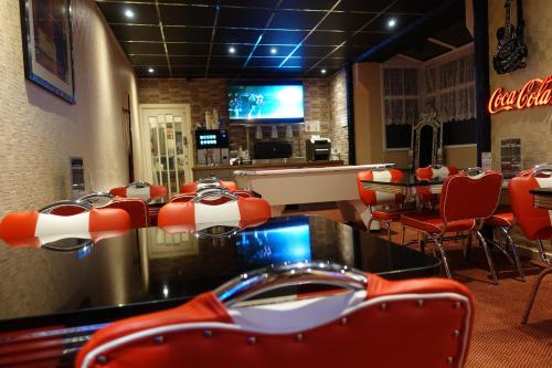 a fast food restaurant with red chairs and a table at The Kings Cross Hotel in Blackpool