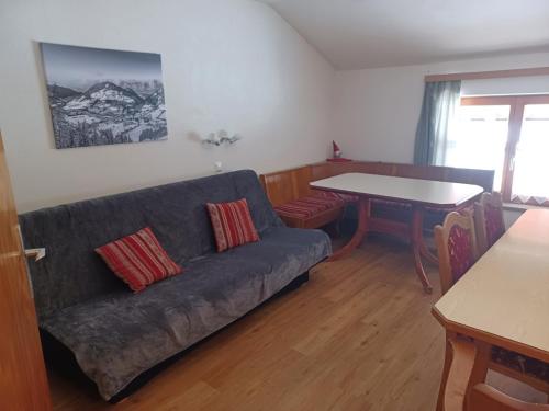 a living room with a couch and a table at Moarhof Appartements in Niederau
