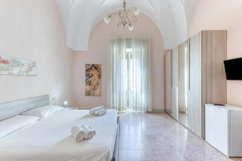 Postel nebo postele na pokoji v ubytování Palazzo Rondine - Affittacamere con cucina