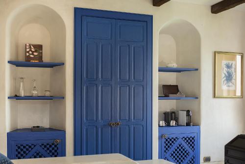 a blue door in a room with blue shelves at Villa Maroc Resort in Pran Buri