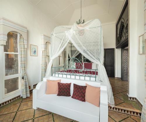 a room with a white bed with a canopy at Villa Maroc Resort in Pran Buri
